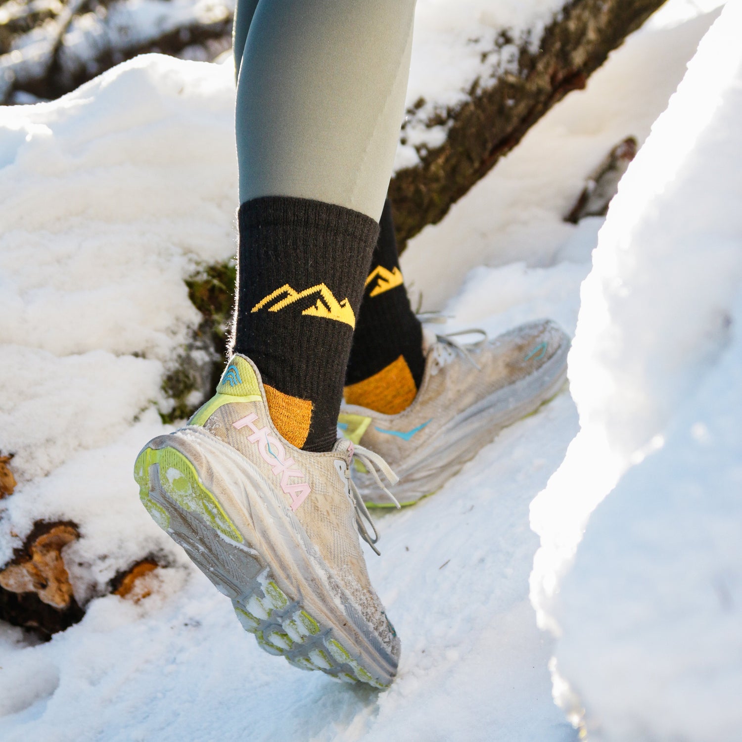 Polku socks-alpacawool- Walking in the snow wearing Polku black and yellow socks.